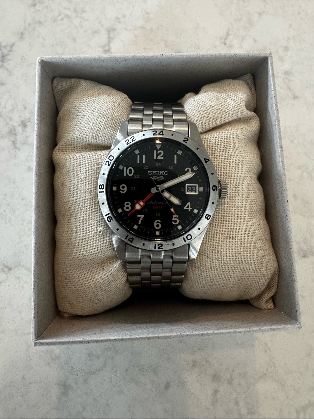 Seiko Black Dial Stainless Steel GMT Watch with Red Accent